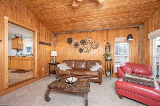 carpeted living room with wood walls, wood ceiling, and vaulted ceiling