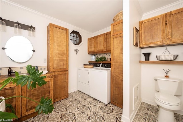 laundry room featuring washer and clothes dryer, light tile patterned floors, cabinet space, ornamental molding, and baseboards