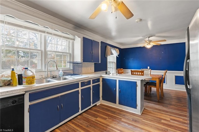 kitchen with kitchen peninsula, dark hardwood / wood-style flooring, sink, and black dishwasher