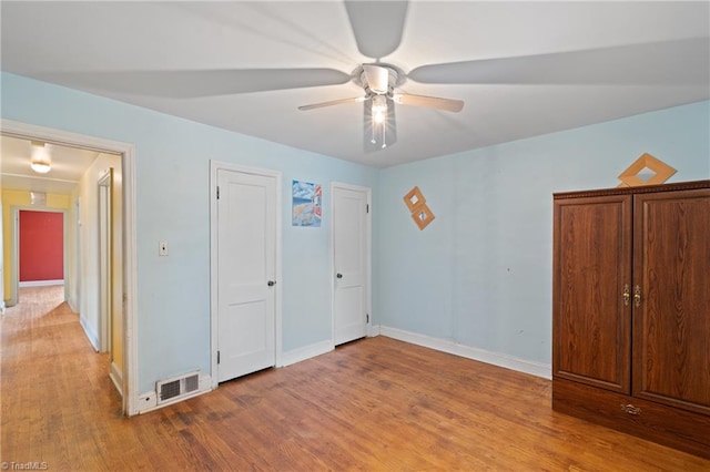 unfurnished bedroom with wood-type flooring and ceiling fan