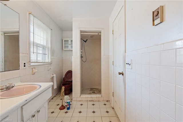 bathroom with tiled shower, tile walls, and vanity