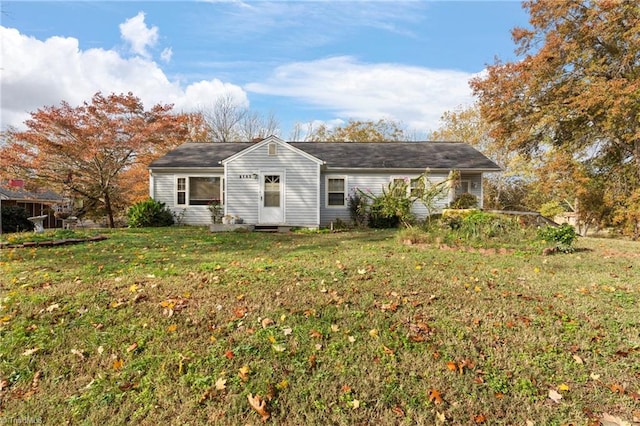 back of house with a lawn