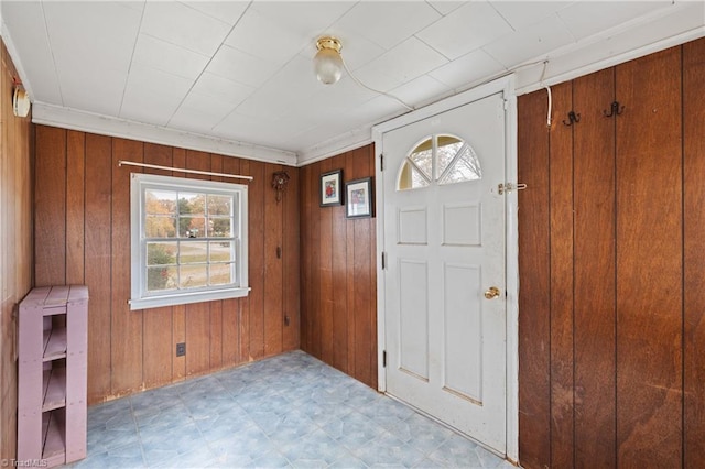 foyer entrance featuring wood walls