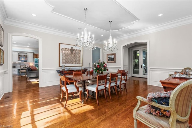 dining space with wood-type flooring, a wealth of natural light, and french doors