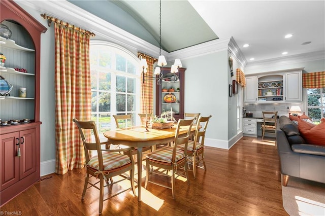 dining room featuring a notable chandelier, vaulted ceiling, ornamental molding, and dark hardwood / wood-style floors