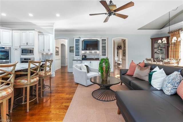 living room featuring crown molding, ceiling fan, and dark hardwood / wood-style floors