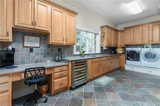 kitchen featuring washer and dryer, sink, wine cooler, ornamental molding, and light stone counters