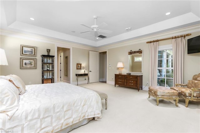 carpeted bedroom with a raised ceiling, ornamental molding, and ceiling fan