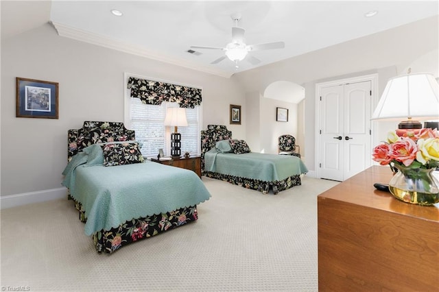 bedroom featuring crown molding, a closet, ceiling fan, and carpet flooring