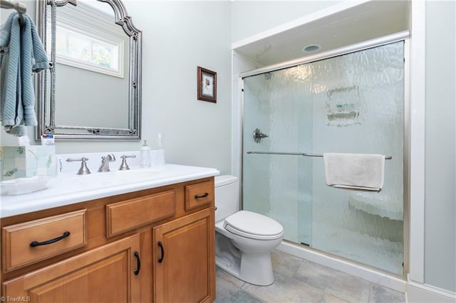 bathroom with vanity, an enclosed shower, and toilet