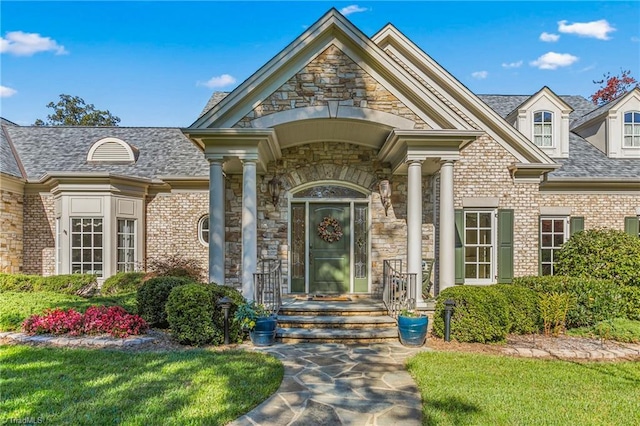 entrance to property featuring a lawn