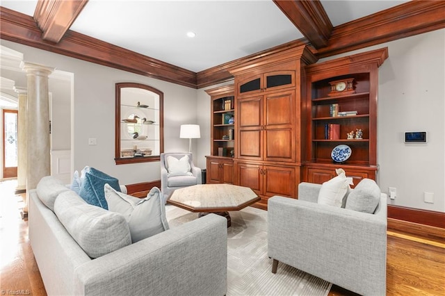 living room featuring decorative columns, ornamental molding, light hardwood / wood-style flooring, and beamed ceiling