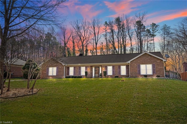 ranch-style house with a front lawn and brick siding