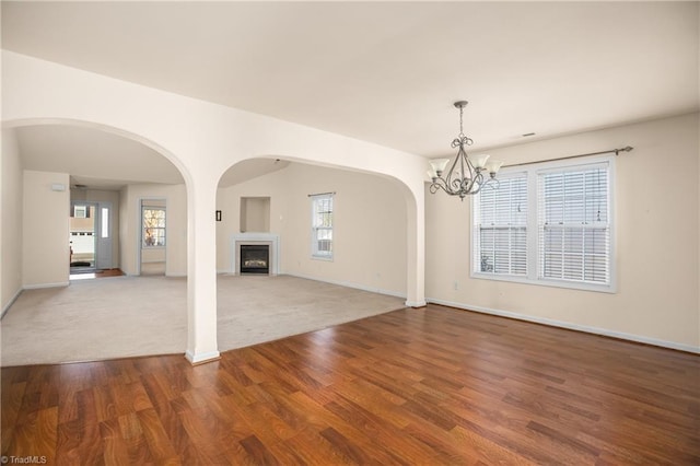 unfurnished room featuring a chandelier and hardwood / wood-style floors