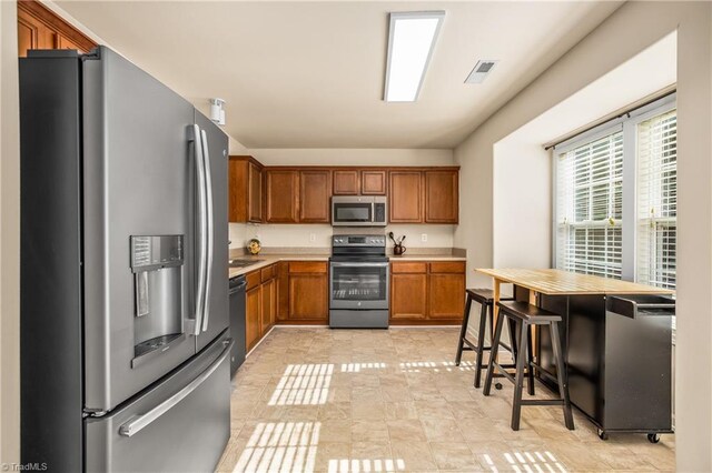 kitchen with stainless steel appliances and a breakfast bar