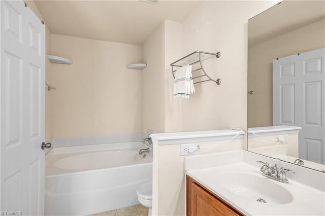 bathroom with vanity, a bath, tile patterned floors, and toilet