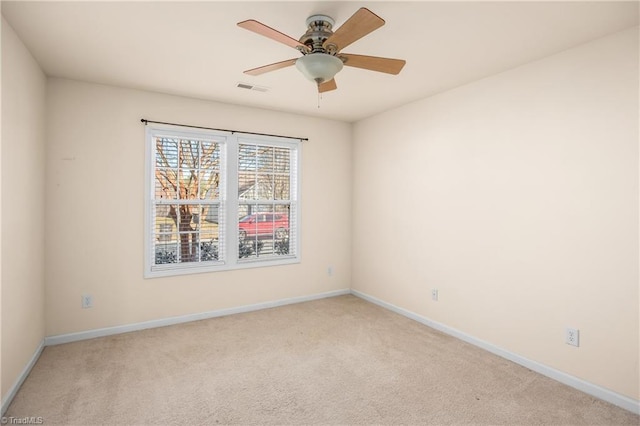 empty room featuring ceiling fan and light carpet