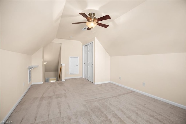 additional living space with light carpet, vaulted ceiling, and ceiling fan