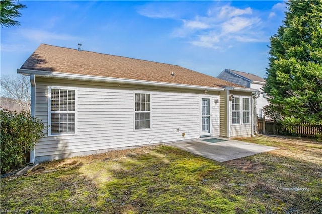 rear view of house featuring a yard and a patio