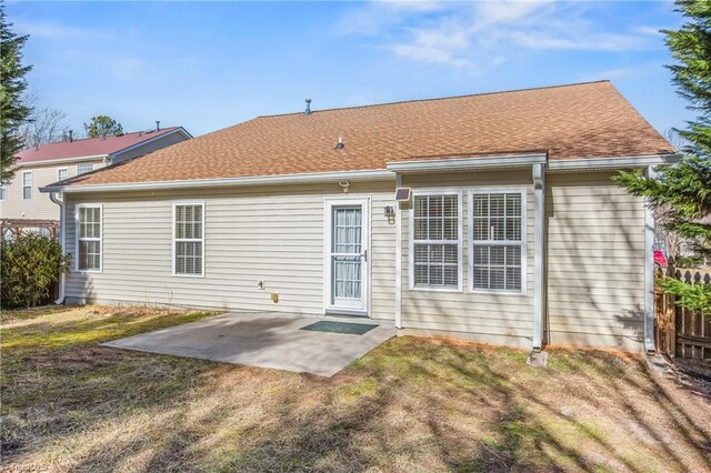 rear view of property featuring a yard and a patio area