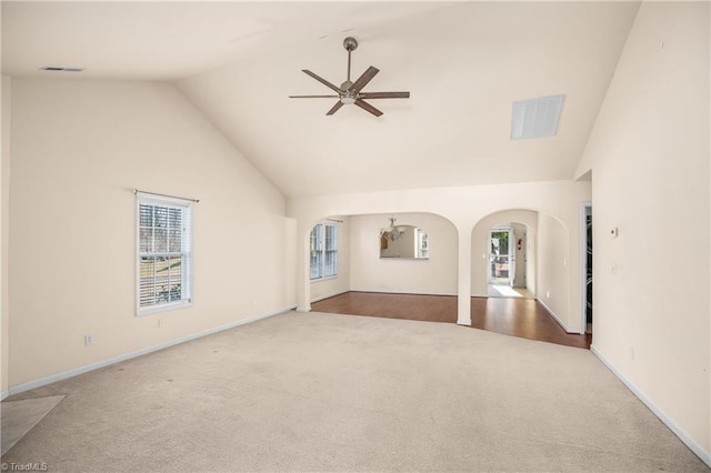 unfurnished living room with ceiling fan, high vaulted ceiling, and carpet