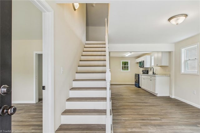 3885 Leo St, Winston-Salem, NC 27105 - stairway with wood finished floors and baseboards