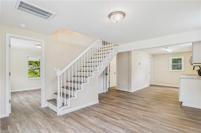 3885 Leo St, Winston-Salem, NC 27105 - stairs with healthy amount of natural light and wood finished floors