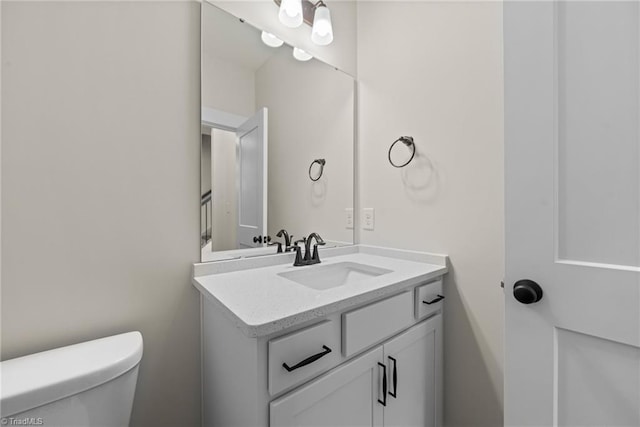 half bath with vanity and toilet