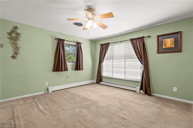 carpeted empty room featuring ceiling fan and a baseboard heating unit