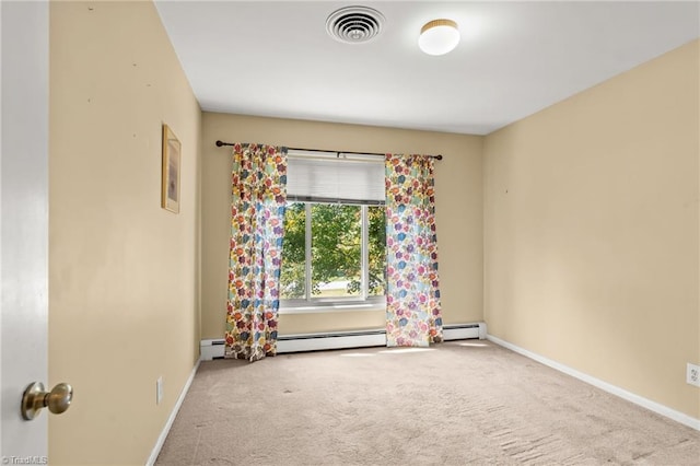 carpeted empty room featuring baseboard heating