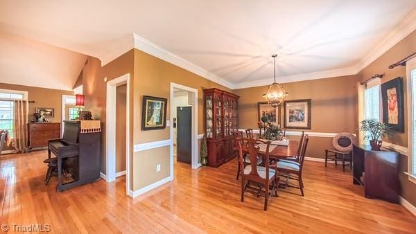 5110 Hartridge Way, Greensboro, NC 27407 - dining area featuring light wood finished floors, a chandelier, baseboards, and ornamental molding