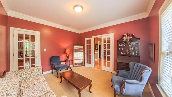5110 Hartridge Way, Greensboro, NC 27407 - sitting room featuring french doors, healthy amount of natural light, ornamental molding, and baseboards