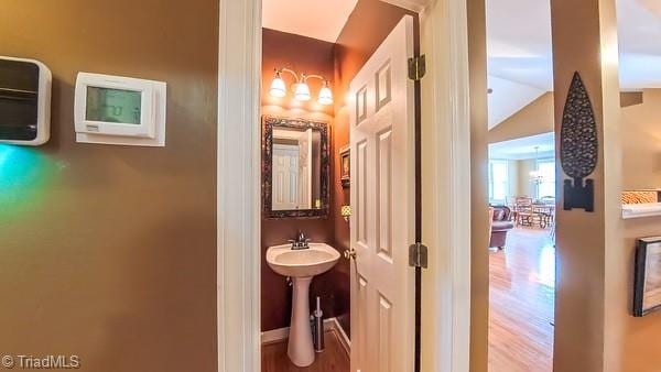 5110 Hartridge Way, Greensboro, NC 27407 - bathroom with wood finished floors, vaulted ceiling, and a sink