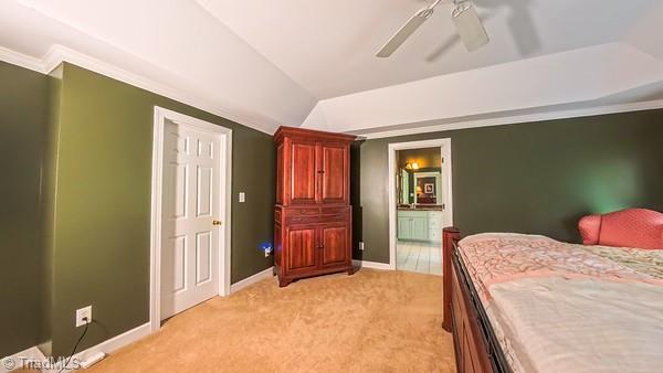 5110 Hartridge Way, Greensboro, NC 27407 - bedroom with light colored carpet, baseboards, lofted ceiling, ensuite bathroom, and ceiling fan