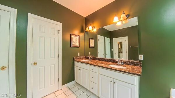 5110 Hartridge Way, Greensboro, NC 27407 - bathroom featuring double vanity, tile patterned flooring, and baseboards