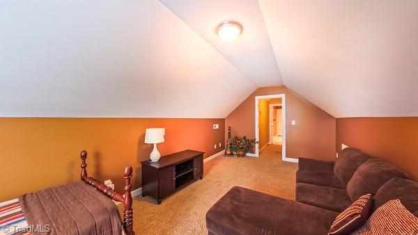 5110 Hartridge Way, Greensboro, NC 27407 - carpeted bedroom featuring vaulted ceiling and baseboards