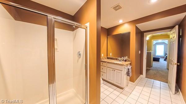 5110 Hartridge Way, Greensboro, NC 27407 - bathroom featuring a stall shower, vanity, tile patterned floors, and recessed lighting