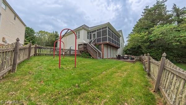5110 Hartridge Way, Greensboro, NC 27407 - rear view of property featuring a sunroom and stairway
