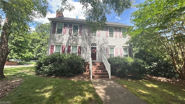 309 Saddlebrook Cir, Lewisville, NC 27023 - colonial home with a chimney and a front lawn