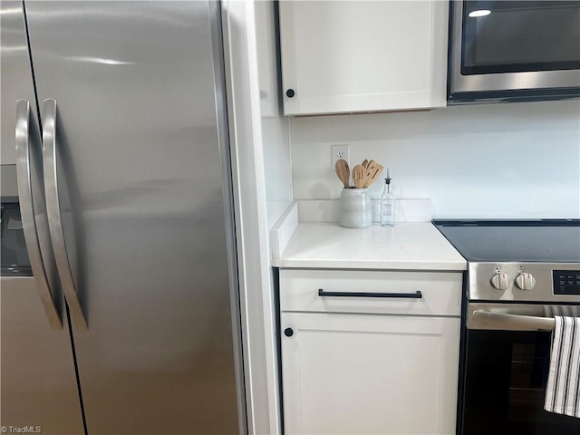 kitchen with white cabinetry and stainless steel appliances