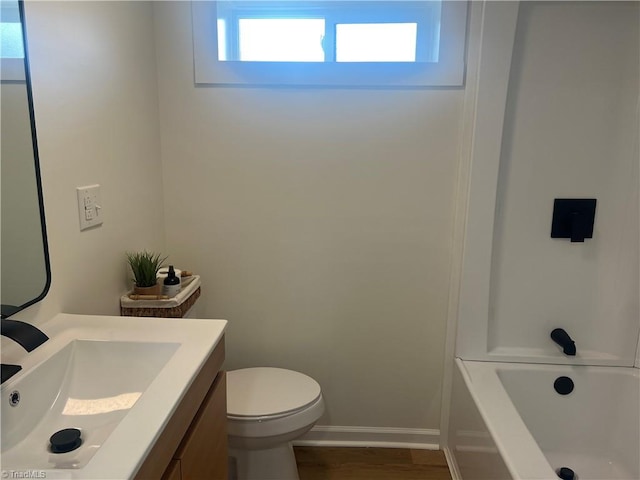 full bathroom featuring vanity, toilet,  shower combination, and a wealth of natural light