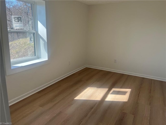 spare room with hardwood / wood-style floors