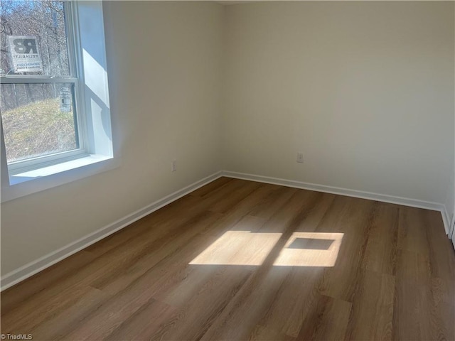 unfurnished room with hardwood / wood-style flooring