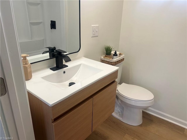 bathroom with vanity, hardwood / wood-style flooring, and toilet