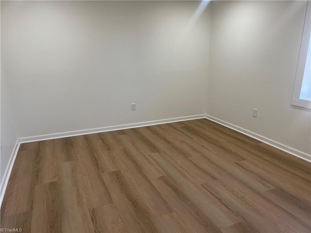 empty room with hardwood / wood-style flooring