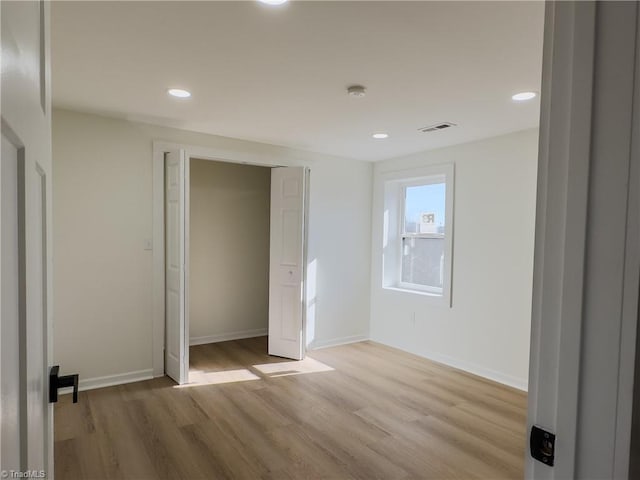 unfurnished bedroom with light wood-type flooring