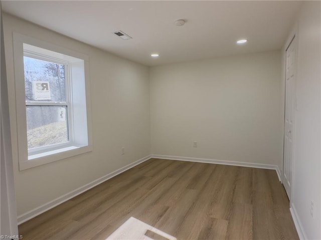 spare room with light wood-type flooring