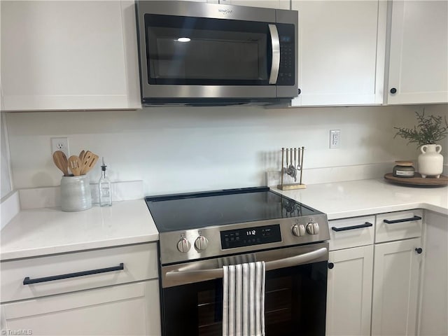 kitchen with appliances with stainless steel finishes and white cabinets