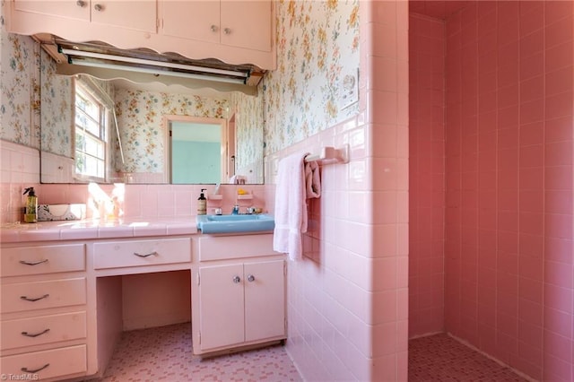 bathroom featuring tile walls, backsplash, tile floors, and vanity