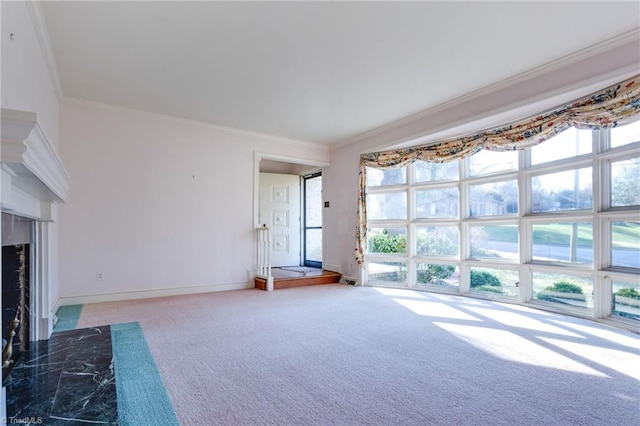 unfurnished living room featuring ornamental molding, carpet, and a premium fireplace